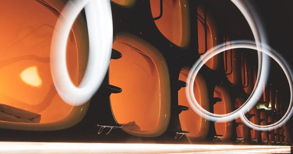Interior of a modern Japanese capsule hotel pod with lighting and privacy curtain