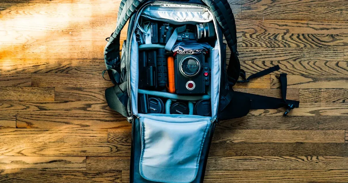 Open travel backpack being efficiently packed for a Japan budget trip