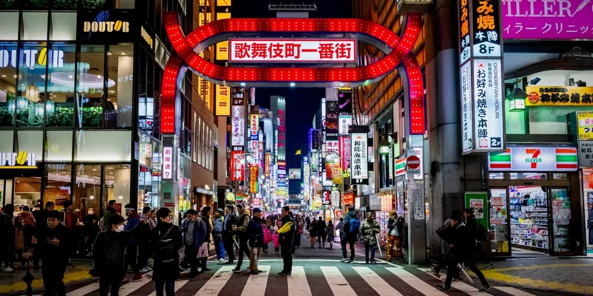 The neon-lit entrance to Kabukicho nightlife district in Shinjuku, Tokyo at night