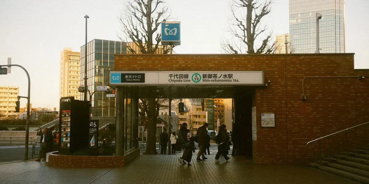 Commuters tapping IC cards at Tokyo train station ticket gates