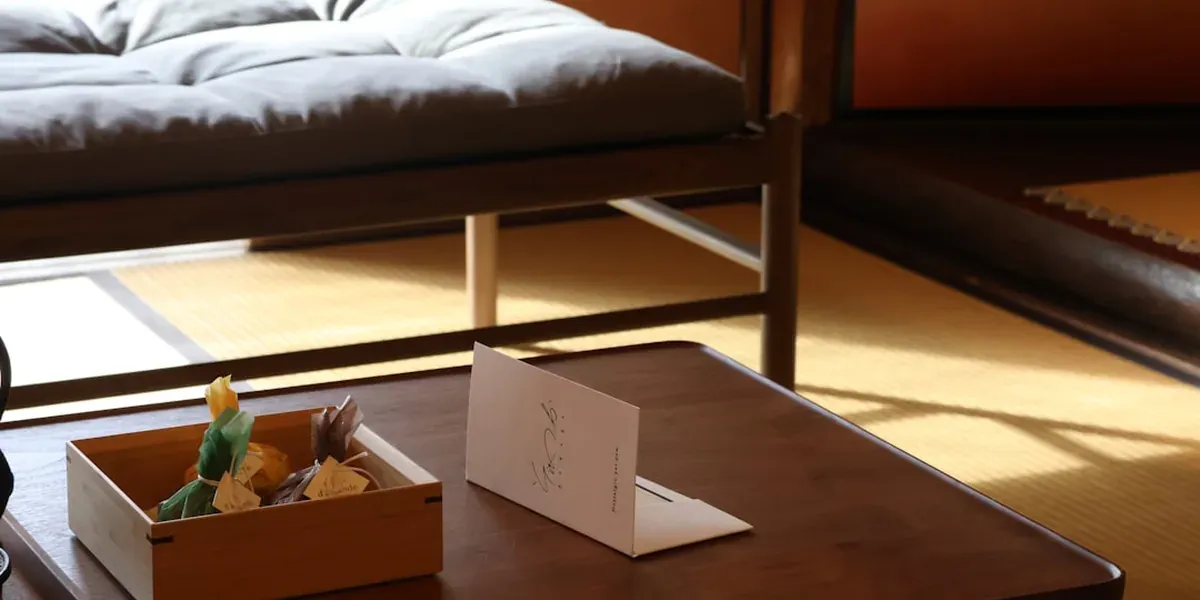Clean hostel dormitory room in Japan with bunk beds and individual reading lights