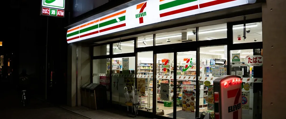 Inside a 7-Eleven Japan convenience store showing the ATM and products