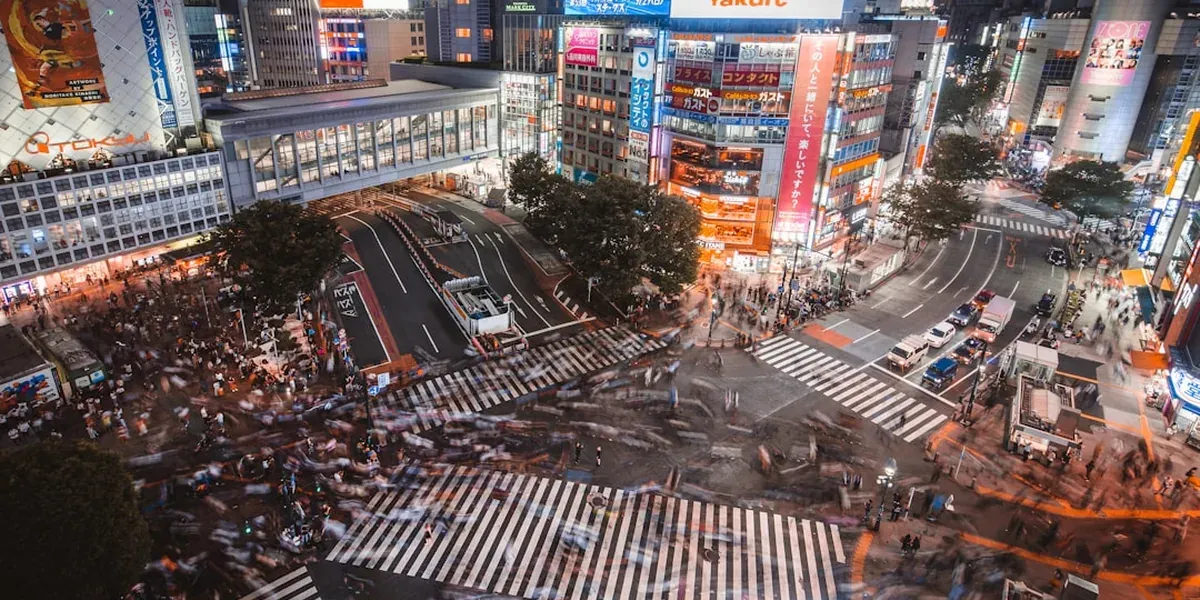 Aerial view of the famous Shibuya crossing with pedestrians and neon advertisements