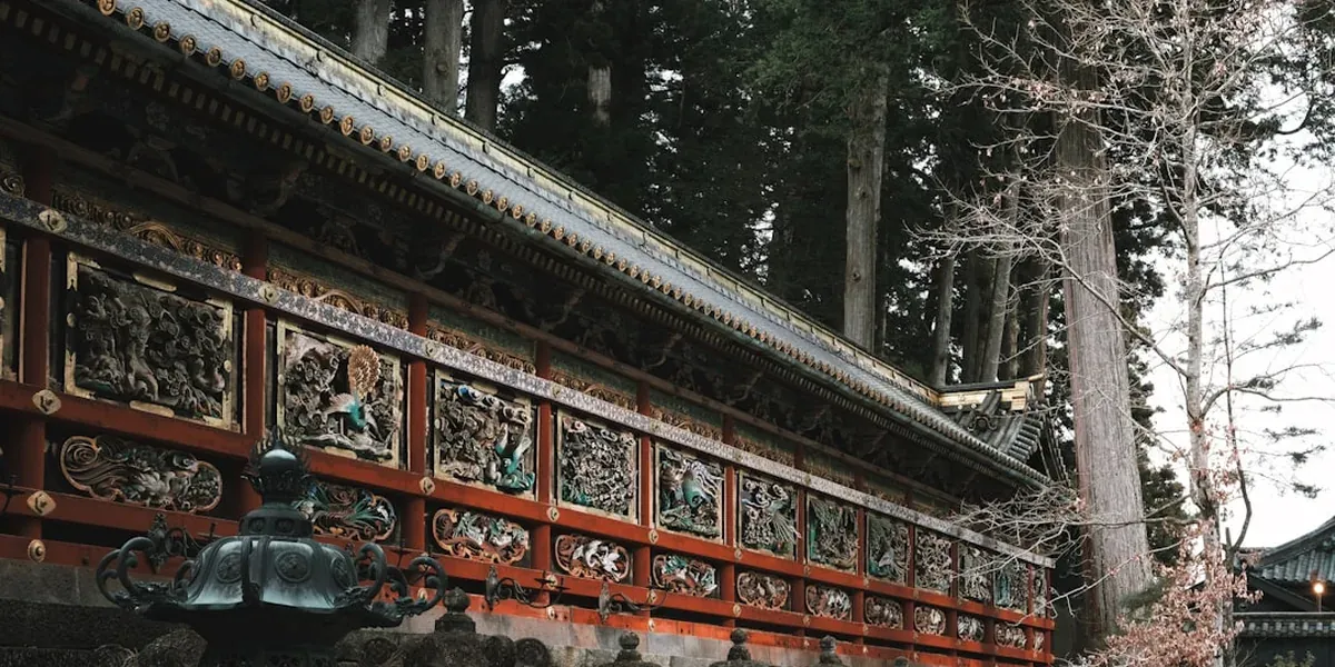 Toshogu Shrine in Nikko showing the ornate carved wooden architecture with lacquered pillars and gold leaf