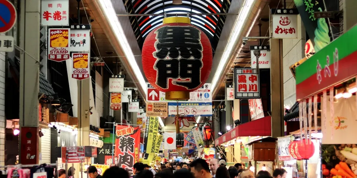 The Kuromon Market in Osaka with fresh seafood, fruit, and street food stalls