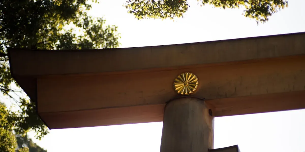 Close-up of the ornate Yomeimon Gate at Toshogu Shrine showing carved wooden pillars with gold leaf