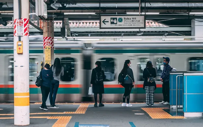 Traveler using a coin locker payment panel at a Japanese station