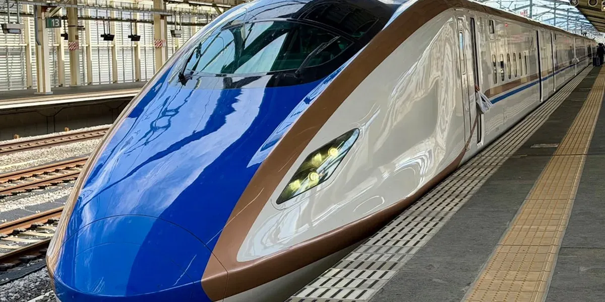 A family riding the Shinkansen bullet train in Japan watching the countryside pass
