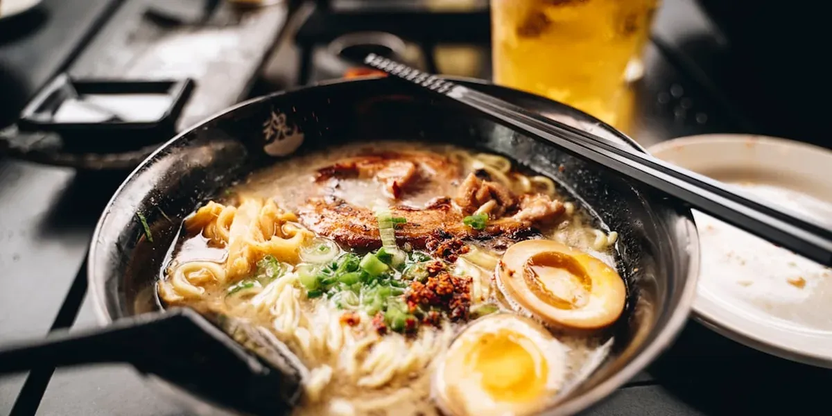 A bowl of Sapporo-style miso ramen with corn, butter, bean sprouts, and chashu pork in a rich broth
