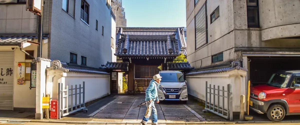 Happy traveler exploring a Japanese street with temples in the background