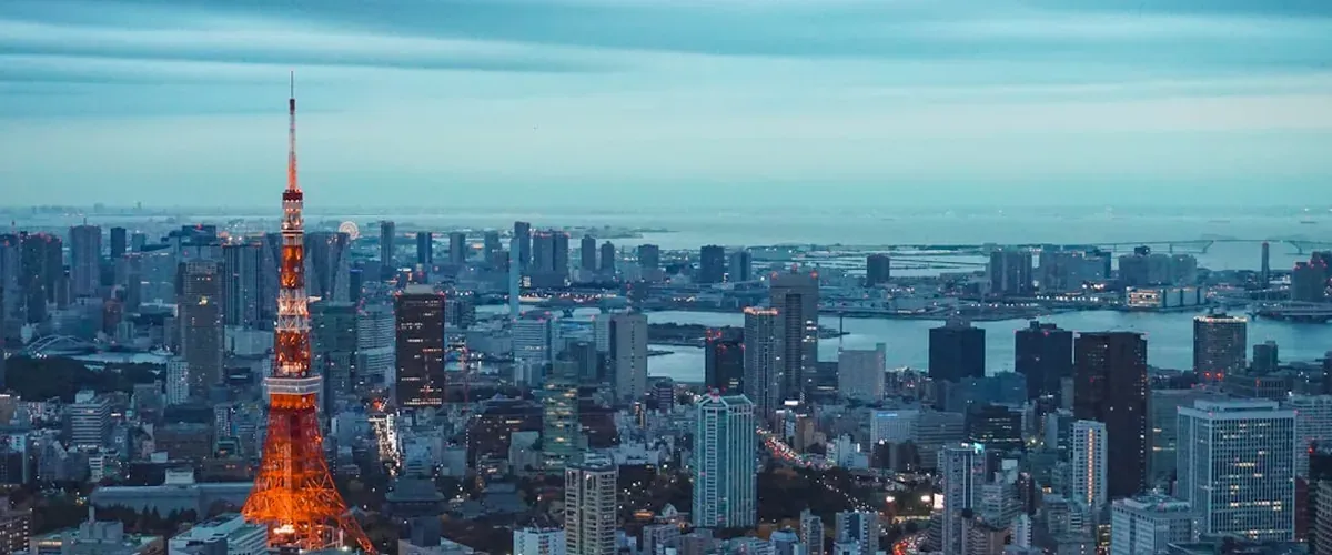 Beautiful Japan sunset view over city and mountains with warm orange sky