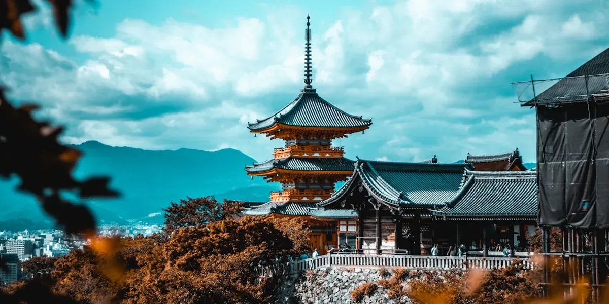 Kiyomizu-dera temple wooden stage overlooking Kyoto with autumn trees in the foreground